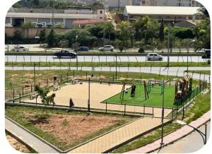 a park with a playground in a city at Appartement Birkhadem in Birkhadem +3 photos