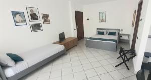 a bedroom with two beds and a television in it at Via Roma OttantaDue in Valmadrera