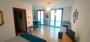 a bedroom with a bed and a dining room with a table at Via Roma OttantaDue in Valmadrera +8 photos