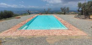 a swimming pool with a tiled floor at Agriturismo Miracco Atanasio Franco "Il Maniero" in Santa Sofia dʼEpiro