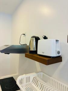 a kitchen with a toaster on a wooden shelf at Hillside Haven-Luxury Room in Nathon Bay