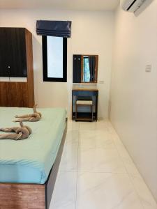 a bedroom with two beds and a desk in it at Hillside Haven-Luxury Room in Nathon Bay