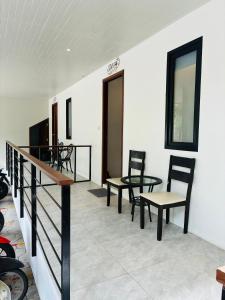 a room with two chairs and a table and a balcony at Hillside Haven-Luxury Room in Nathon Bay