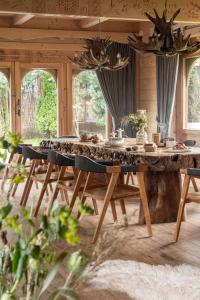 a large wooden table in a living room at Bajkowa LUX Magiczne Domki z Jacuzzi in Murzasichle
