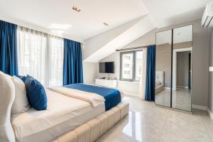 a bedroom with a large bed and blue curtains at Elite World Homes Istanbul Bosphorus in Istanbul