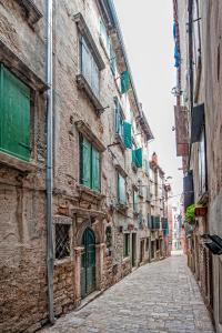 an alley in an old town with buildings at Apartments Aalvar and Aalto in Rovinj