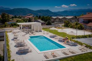 an overhead view of a pool with chairs and umbrellas at Terra Vinum in Neméa
