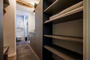 a walk in closet with black shelves in a bathroom at Apartments Aalvar and Aalto in Rovinj