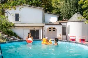 two women and a child in a swimming pool at Granducato di Monteballante in Pesaro