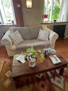 a living room with a couch and a coffee table at Pathways, Beachwood Cottage in Bath