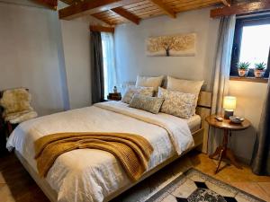 a bedroom with a large bed and a window at Bratis House in Vartholomio