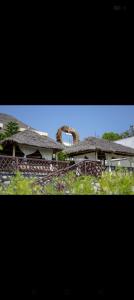 two pictures of a house with a roof at Sky Beach Resort Ltd in Kisumu