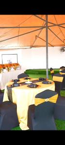 a group of tables in a tent with yellow bows at Sky Beach Resort Ltd in Kisumu
