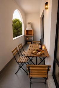 a dining room with a table and chairs and a window at ENJOY POOL, BEACH and more at this nice 2bedroom apartment only 3 minutes from Mareta's Beach in Sagres