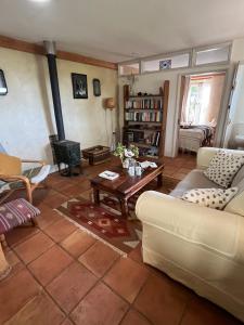 a living room with a couch and a coffee table at Pathways, Beachwood Cottage in Bath