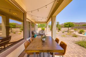 a porch with a wooden table and chairs at Fire Pit & Large Yard! Luxury Anthem Escape in Anthem