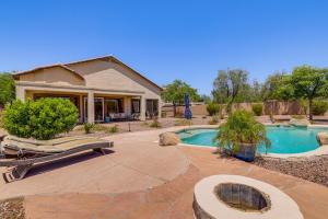 a backyard with a swimming pool and a house at Fire Pit & Large Yard! Luxury Anthem Escape in Anthem