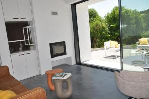 a living room with a large glass door and a table at Vale De Água Equestrian Resort in Odemira