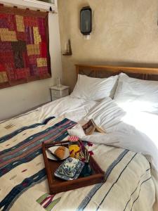 a bed with a tray of food on it at Pathways, Beachwood Cottage in Bath