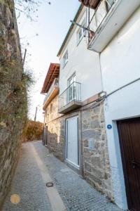 a building with a balcony on the side of it at Casa do Foral by Lethes Legacy in Ponte de Lima