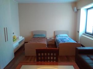A bed or beds in a room at Maison d'Elite