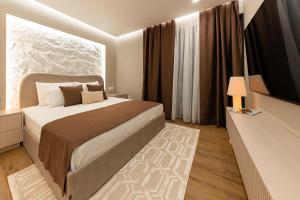 a bedroom with a bed and a large window at Armal Studio in Mostar