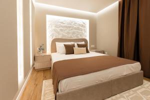 a bedroom with a large bed and a window at Armal Studio in Mostar