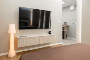a living room with a television on a wall at Armal Studio in Mostar +21 photos