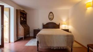 a bedroom with a bed and a mirror on the wall at Quinta Da Longra in Vizela