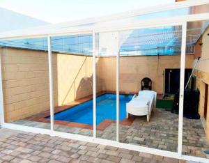 a screened in swimming pool in a house at La Casona De Cuellar in Cuéllar +12 photos