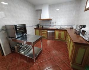 a kitchen with wooden cabinets and a counter top at La Casona De Cuellar in Cuéllar