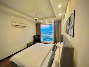 a hotel room with a bed and a window at SkyPark Premium Hotel Serviced Apartments - LMY Hospitality Gulberg Islamabad in Islamabad