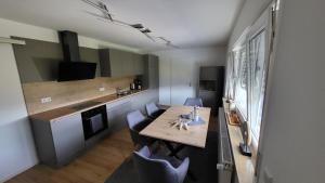 a small kitchen with a wooden table and chairs at FeWo Panoramablick Geislingen in Geislingen an der Steige +9 photos