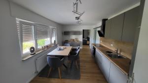 a kitchen with a table and chairs and a sink at FeWo Panoramablick Geislingen in Geislingen an der Steige
