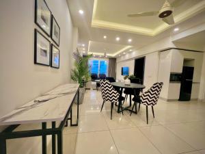 a dining room and living room with a table and chairs at SkyPark Premium Hotel Serviced Apartments - LMY Hospitality Gulberg Islamabad in Islamabad