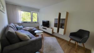 a living room with a couch and a chair at FeWo Panoramablick Geislingen in Geislingen an der Steige