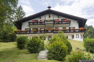 a house on a hill with flower boxes on it at Bergschlössl Whg 3 in Oberaudorf