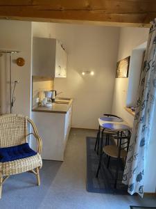 a small kitchen with a table and a table and chairs at Mit einem Traumblick App 37 in Oberaudorf