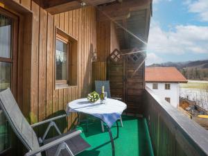a table on the balcony of a house at Mit einem Traumblick App 37 in Oberaudorf +2 photos