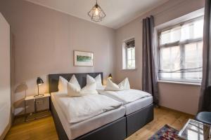 a bedroom with a large bed with white pillows at Villa Stigloh in Oberaudorf
