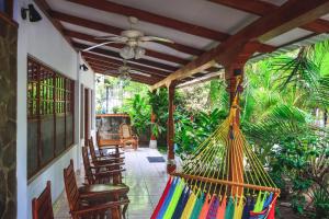 a porch with a hammock on a house at Hotel Gracia in San Juan del Sur