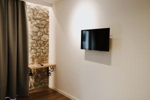 a flat screen tv hanging on a wall at Albulena Hotel & Camping in Shkodër