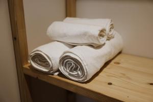a pile of towels sitting on a wooden shelf at Albulena Hotel & Camping in Shkodër +31 photos