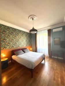 a bedroom with a large bed with a painting on the wall at Casa Lucibell in Prato