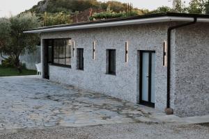 a brick building with windows and a driveway at Albulena Hotel & Camping in Shkodër