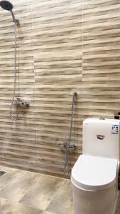 a bathroom with a toilet and a shower at فندق أوريون orion hotel in Al-ʿUla