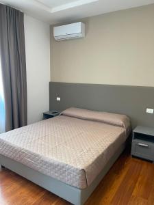 a bedroom with a bed and a air conditioner at B&B Casa Claudio in San Giovanni Rotondo