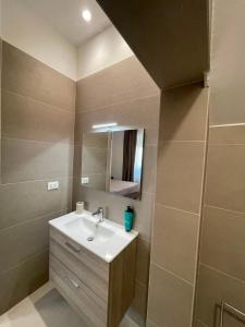 a bathroom with a sink and a mirror at B&B Casa Claudio in San Giovanni Rotondo