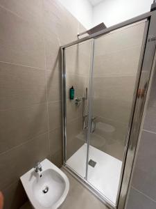 a bathroom with a shower and a toilet and a sink at B&B Casa Claudio in San Giovanni Rotondo