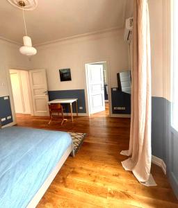 a bedroom with a bed and a table in a room at Casa Lucibell in Prato